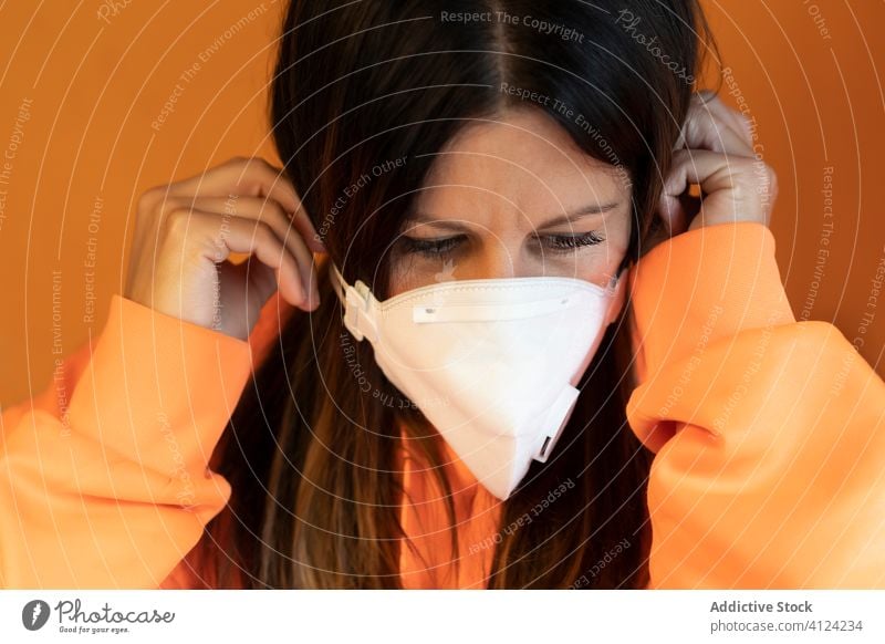 Woman putting on protective mask woman coronavirus covid prevent safe health care pandemic young female casual put on covid 19 covid19 infection epidemic danger