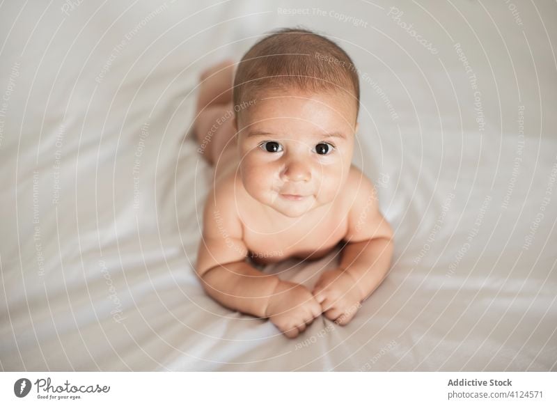 Cute baby lying on bed at home cute cozy smile soft comfort relax infant adorable innocent joy little bedroom child kid happy rest sweet childhood charming