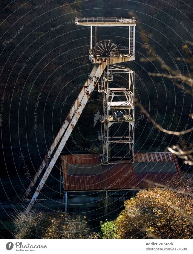 Part of abandoned coal mine in forest mechanism nature neglect desert desolate countryside industrial metal old empty sunny asturias spain derelict ownerless