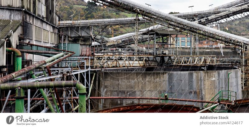 Industrial facilities and trolleys for coal at abandoned coal mine structure building metallic gray huge corrosion dirty industry rust desert old green factory