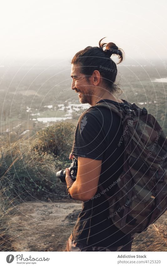 Traveling man taking picture of nature on cliff take photo smiling edge majestic landscape picturesque photographer traveler breathtaking forest camera freedom