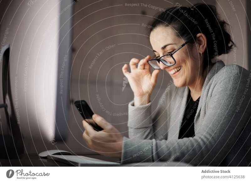 Focused woman working with gadgets at home smartphone computer telework using browsing young casual female serious concentrate focus blank screen empty screen