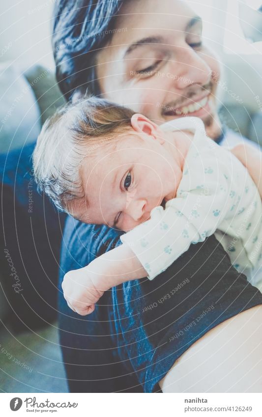 Young single father caring her newborn baby dad family parenthood babyhood new born care new masculinity modern fatherhood hug fragile fragility mood emotions