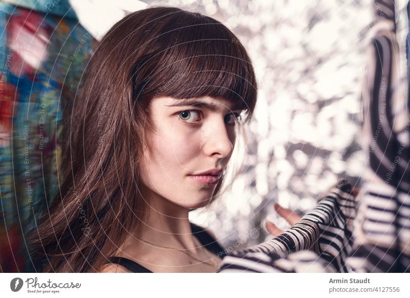 portrait of a beautiful teenage girl with her clothes woman teenager smile cunning sophisticated wardrobe looking browsing shirt bangs young casual caucasian