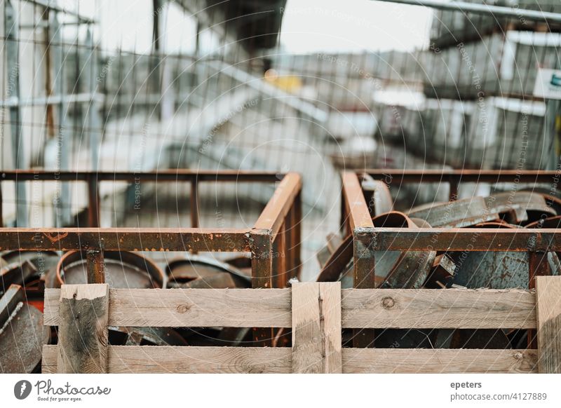 A bunch of metal pieces at a construction site in Hamburg Germany blue dirty fence greenhouse gas grey labour lids metallic rough work Construction site