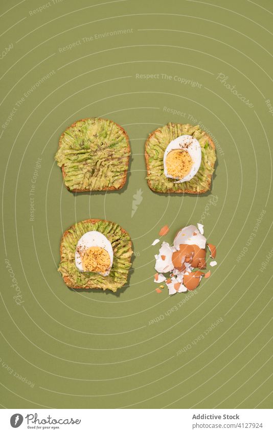 Avocado toast with eggs avocado guacamole fruit food green healthy pop minimal breakfast bread vegetarian veggie cool still life tasty top view from above