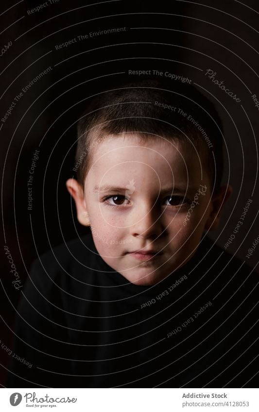 Pensive kid isolated on black pensive sad portrait boy thoughtful serious little child childhood person human face cute posing casual calm auto transport dream