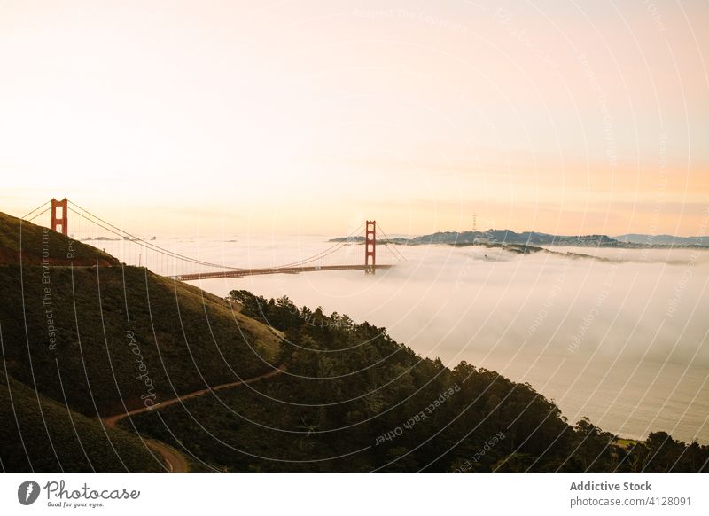 Famous Golden Gate Bridge on foggy evening bridge golden gate sightseeing sunset famous way strait construction architecture landscape sundown destination warm