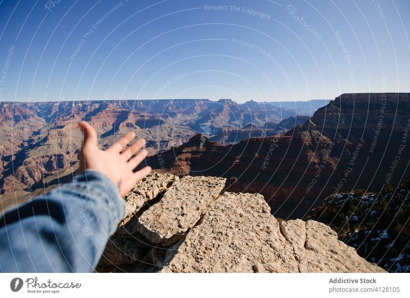 Stunning view of rocky terrain traveler desert cliff nature landscape explore freedom hand journey tourism relax tourist wild idyllic peaceful scenic vacation