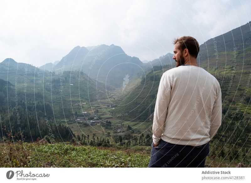 Man admiring majestic landscape of mountain valley man admire travel enjoy scenic peak fog male vietnam asia scenery amazing highland morning summer spectacular