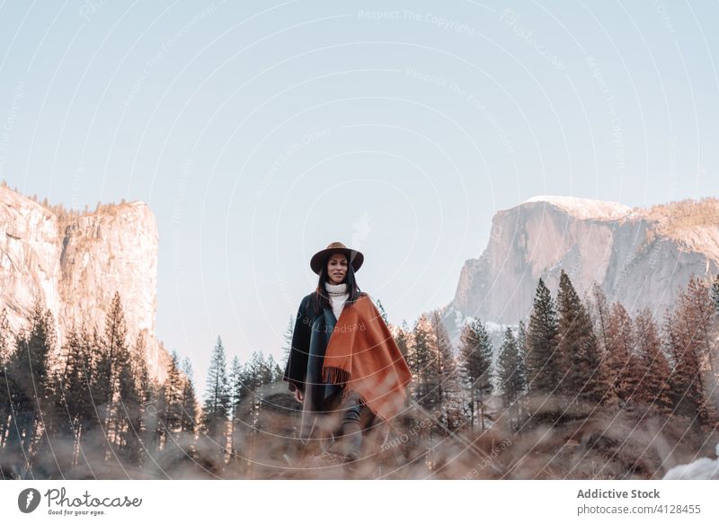 Happy woman enjoying sunny day in mountains travel happy relax forest yosemite park cliff edge rock stone national female style trendy landscape young boho