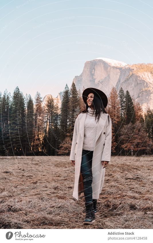 Happy woman enjoying sunny day in mountains travel happy relax forest yosemite park cliff edge rock stone national female style trendy landscape young