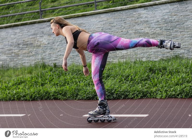 Sporty woman rollerblading along bicycle path rollerblade skate park motion roller blade balance sportswear entertain sporty female street active sportswoman