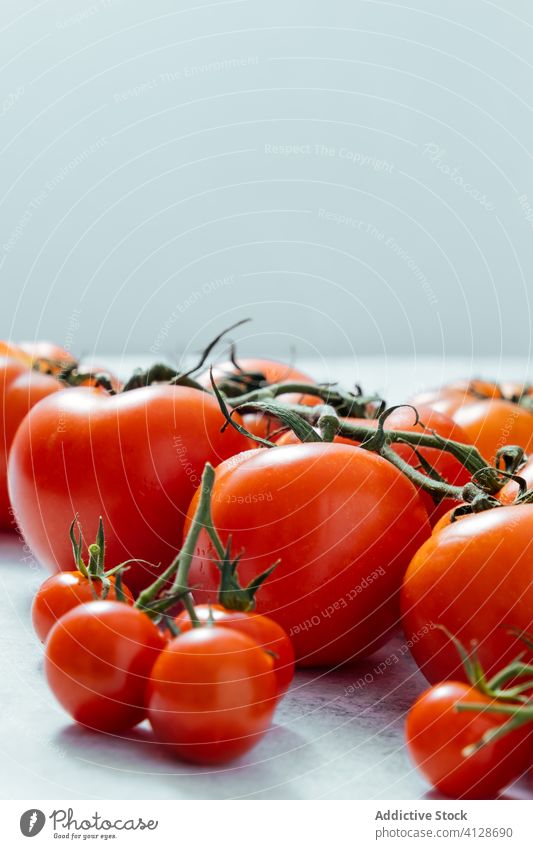 Fresh ripe large and little tomatoes on table harvest food meal fresh stem leek cherry healthy red nutrition vitamin pepper agriculture raw herb small berry row