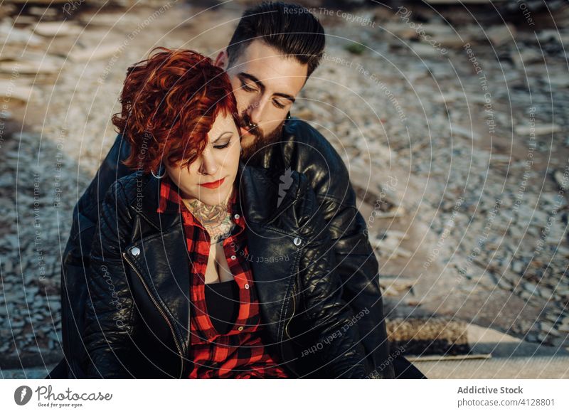 Happy young couple embracing near weathered building love embrace happy hipster street shabby together hug relationship tattoo boyfriend girlfriend affection