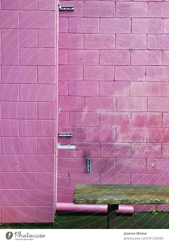 Pink brick wall with brown seat. pink background pink wall Gritty Brick wall Seating Exterior shot Wall (barrier) Wall (building) Facade Old