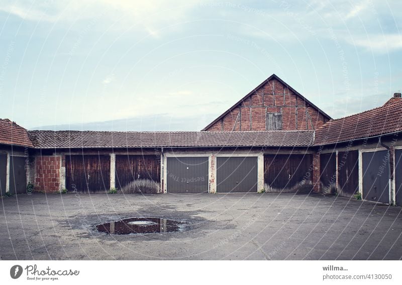 close-knit garage community Garage community garages Garage door Puddle Places Gloomy Deserted Garage complex Building