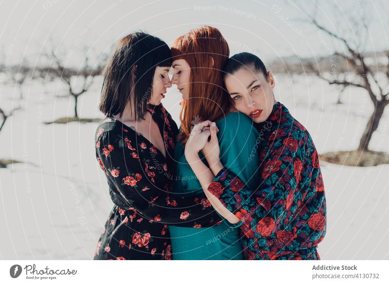 Sensual girlfriends embracing in snowy park women sensual model winter style relationship embrace lesbian tender love affection nature hug romantic close