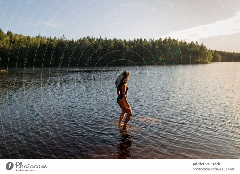 Woman in swimsuit standing in lake woman water calm sunset enjoy summer majestic scenery female forest landscape tranquil serene harmony peaceful idyllic wood