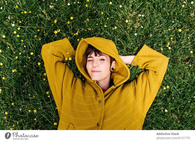 Relaxed informal woman lying on meadow relax enjoy summer lawn blink green piercing brutal carefree female grass rest nature flower cheerful holiday weekend