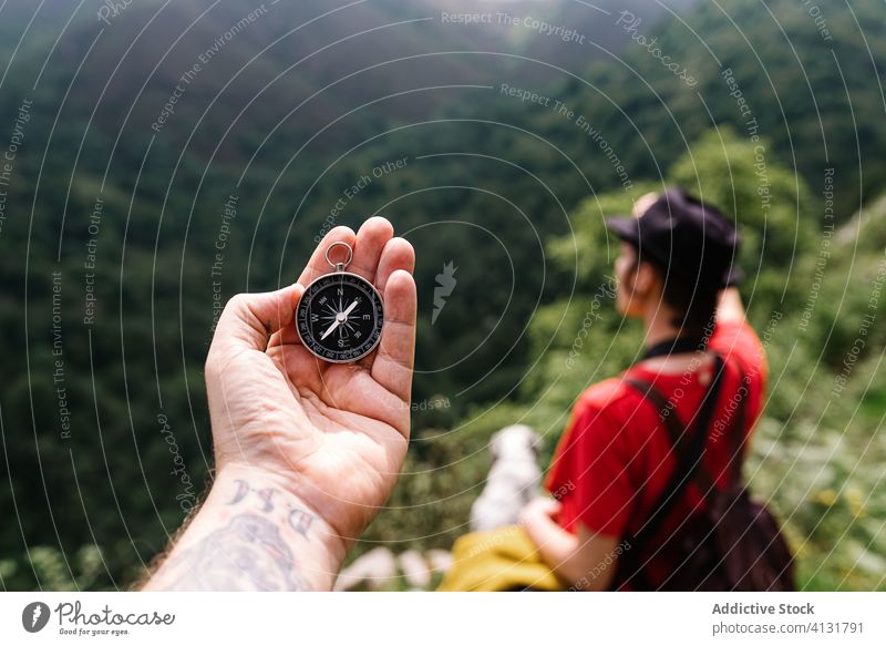 Crop anonymous traveler with metal compass man hand tourist navigate orientate journey vacation direction location summer wanderlust explore destination