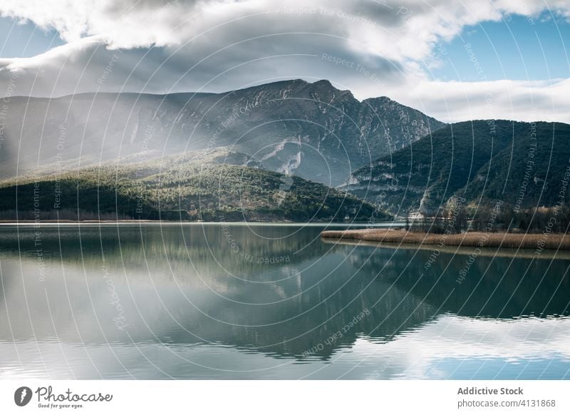 Rocky mountains reflected in calm lake range landscape rock cloudy nature reflection rough spain montsec majestic magnificent water surface mirror tranquil