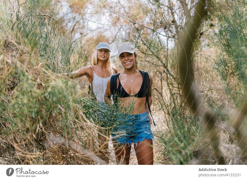 Traveling women on green hill vacation summer friend together travel sunny tourist cheerful friendship friendly grass enjoy nature smile happy holiday weekend