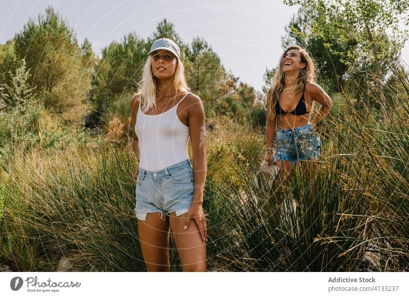 Traveling women on green hill vacation summer friend together travel sunny tourist cheerful friendship friendly grass enjoy nature smile happy holiday weekend