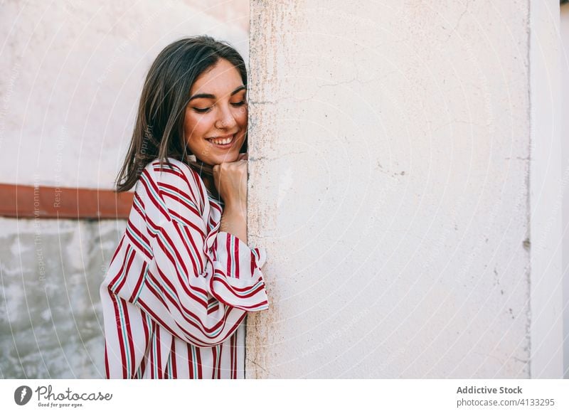 Charming woman near stone wall in city tranquil charming style street content trendy shabby female urban relax exterior old weathered slim fashion calm lady