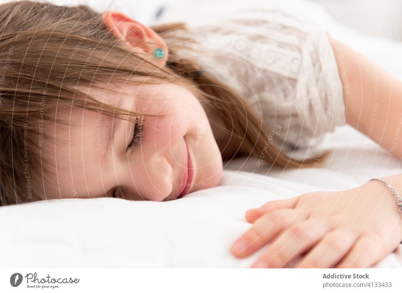 Cute girl relaxing on bed lying child cute soft weekend home rest kid childhood cozy comfort bedroom flat tranquil serene calm apartment adorable idyllic sweet