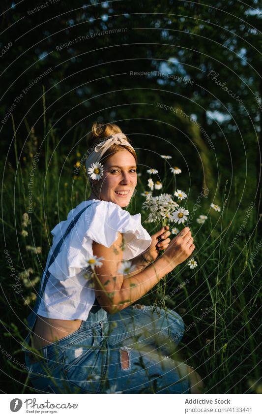 Calm female resting on green meadow in spring woman chamomile field rural pick collect smell calm enjoy bouquet fresh flower nature young bloom blossom relax