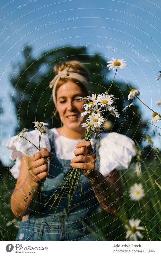 Calm female resting on green meadow in spring woman chamomile field rural pick collect smell calm enjoy bouquet fresh flower nature young bloom blossom relax