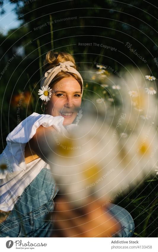 Female holding bouquet of blooming chamomile woman flower love field show give present care demonstrate happy vertical summer person smile blossom hand nature