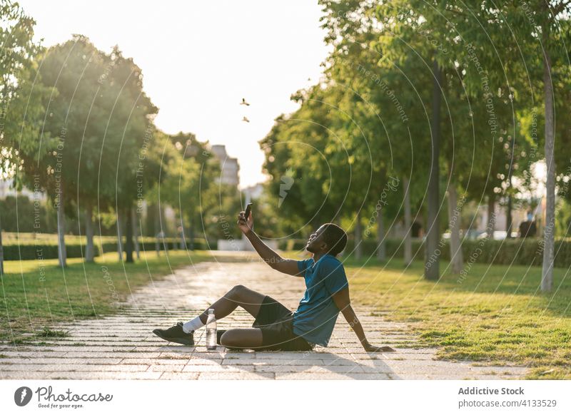 Black man taking selfie phone happy park male relaxed resting outdoors mobile smiling black african people young happiness cheerful adult friends portrait youth