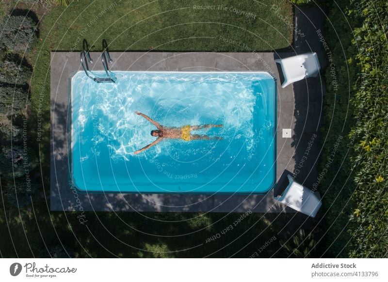 Relaxed woman swimming in pool float relax summer rest chill water yard backyard male lifestyle holiday poolside sunbath carefree enjoy summertime garden patio