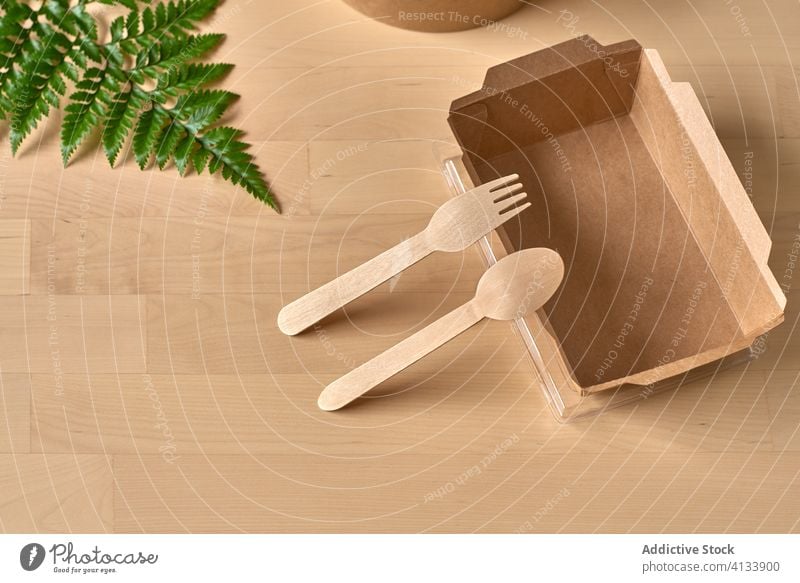 Cardboard box and wooden utensils package carton recycle disposable eco friendly ecology natural concept zero waste organic arrangement composition cardboard