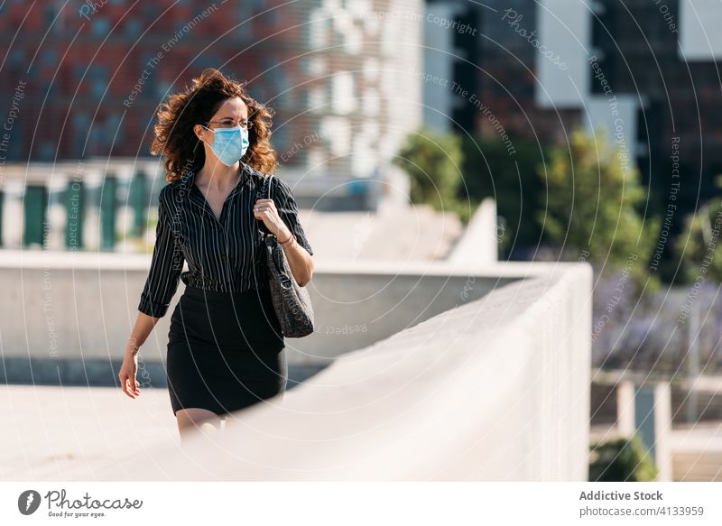 Woman wearing a surgical mask while walking through the city. influenza girl illness disease epidemic coronavirus covid-19 health portrait respiratory people