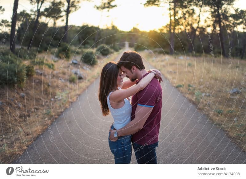 Loving couple embracing in park tender embrace sunny together love happy smile relationship romantic garden hug affection summer date close romance enjoy