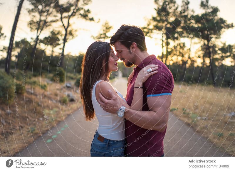 Loving couple embracing in park tender embrace sunny together love happy smile relationship romantic garden hug affection summer date close romance enjoy