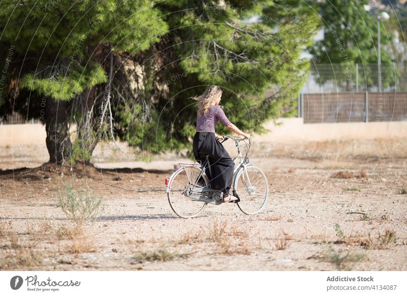 Tranquil woman with bicycle in park bike summer weekend enjoy walk cyclist calm female sunny tranquil serene outfit daytime rest relax green tree recreation