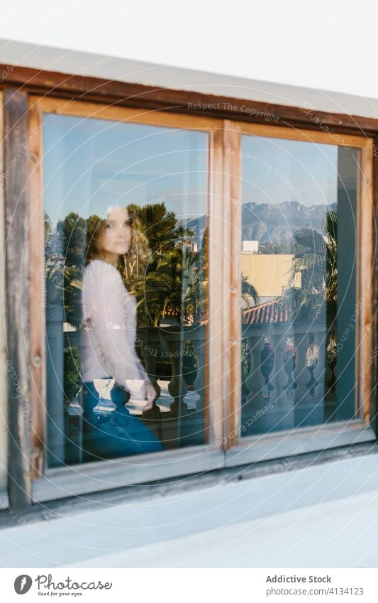 Calm woman near window at home tranquil tropical relax rest calm summer paradise serene female casual chill peaceful idyllic enjoy comfort content harmony