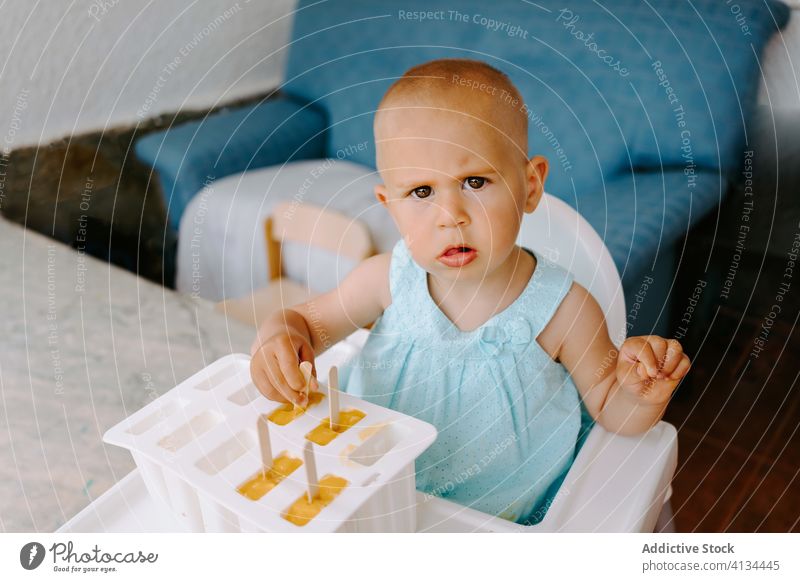 Adorable girl with mold of homemade ice lollies eat popsicle toddler ice cream summer adorable delicious treat terrace kid little child childhood relax carefree