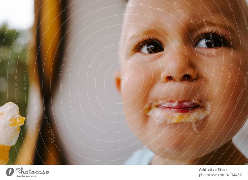 Adorable toddler eating delicious ice cream popsicle dirty mouth child enjoy tasty homemade summer adorable treat terrace rest kid little childhood relax