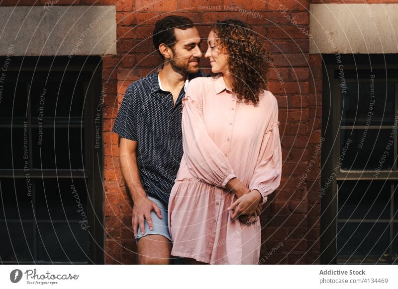 Smiling couple kissing on street love hug city relationship embrace together sunny romantic new york america united states usa building brick wall smile urban