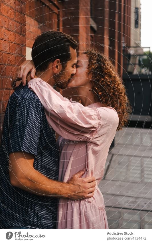 Smiling couple kissing on street love hug city relationship embrace together sunny romantic new york america united states usa building brick wall smile urban