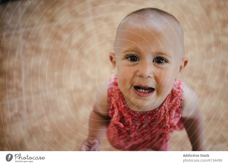 Little girl standing looking at camera adorable cute child kid innocent preschool little childhood portrait expressive interest charming home carefree