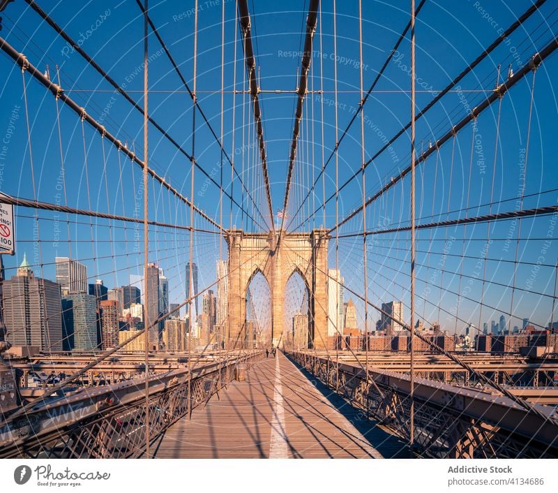 Suspension bridge over river in contemporary city brooklyn architecture building construction cityscape new york structure landmark famous design style travel