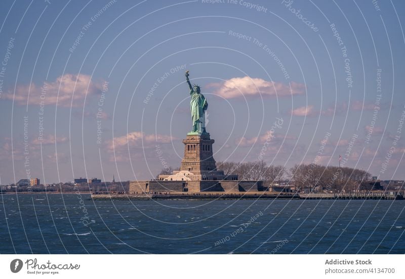 Famous Statue of Liberty against cloudy sky statue liberty new york sculpture famous sight freedom america landmark architecture travel tourism usa destination