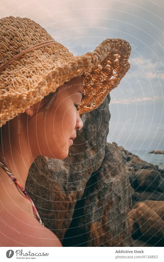 Traveling woman on rocky seashore holiday summer season travel admire tourist female stone spectacular seascape vacation nature idyllic tourism coast