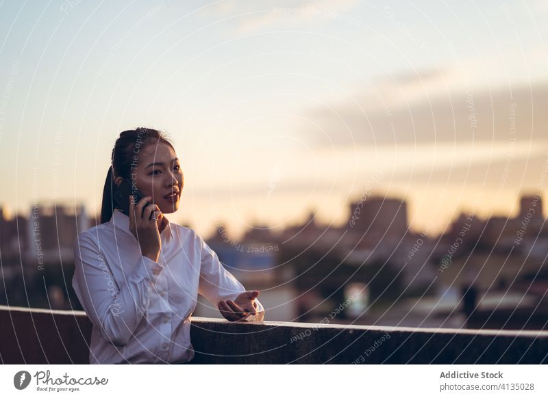 Busy woman talking on smartphone work using businesswoman formal rooftop device gadget asian young female internet communicate browsing connection entrepreneur